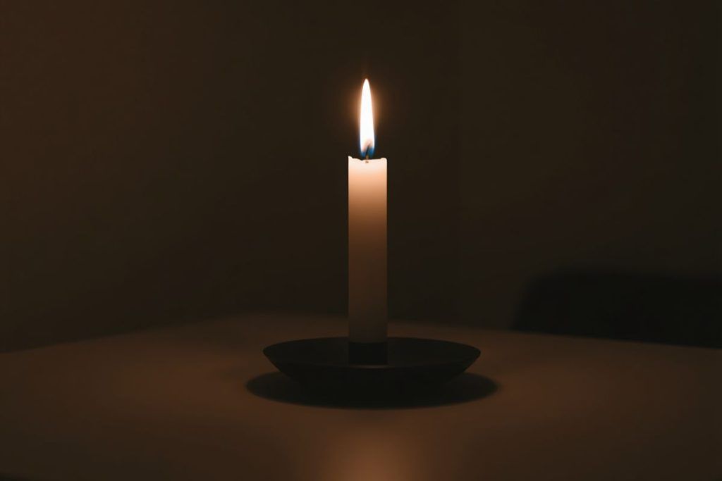 A single candle flame at eye level for fire kasina meditation