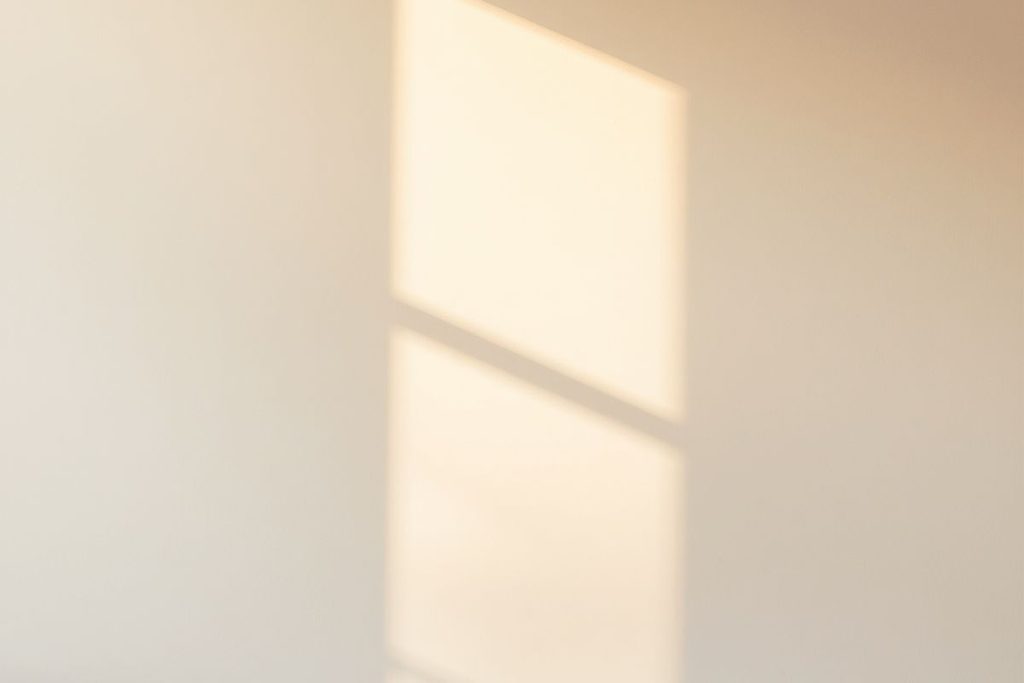 A soft patch of sunlight on a wall for light kasina meditation